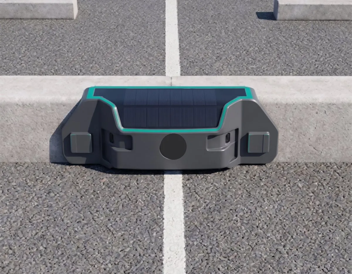 A solar-powered kerb-face parking sensor at the edge of a marked bay
